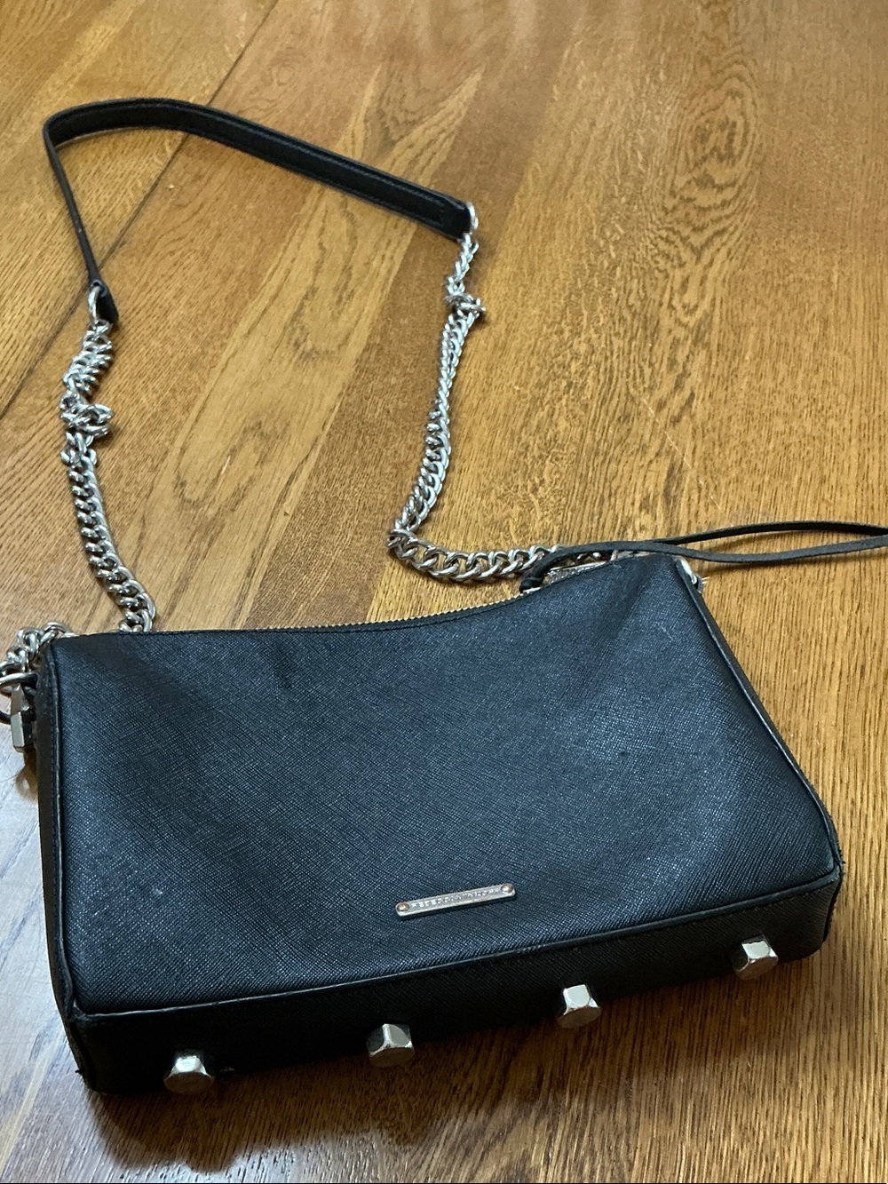 Woman’s Rebecca Minkoff black crossbody with silver chain strap. Gently used.